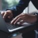 Businessman Typing On Laptop